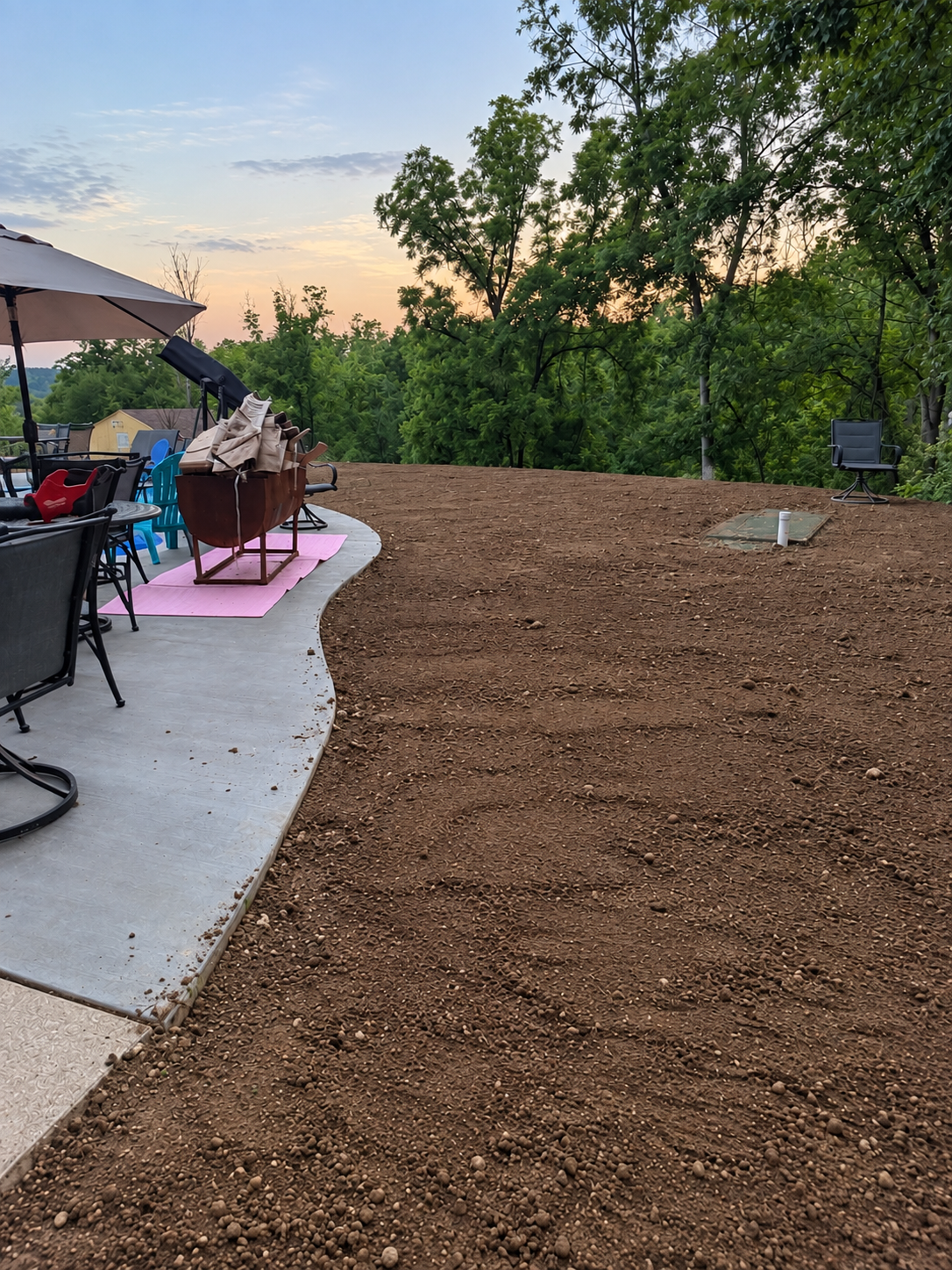 Graded and prepped yard ready for sod, patio view at sunset