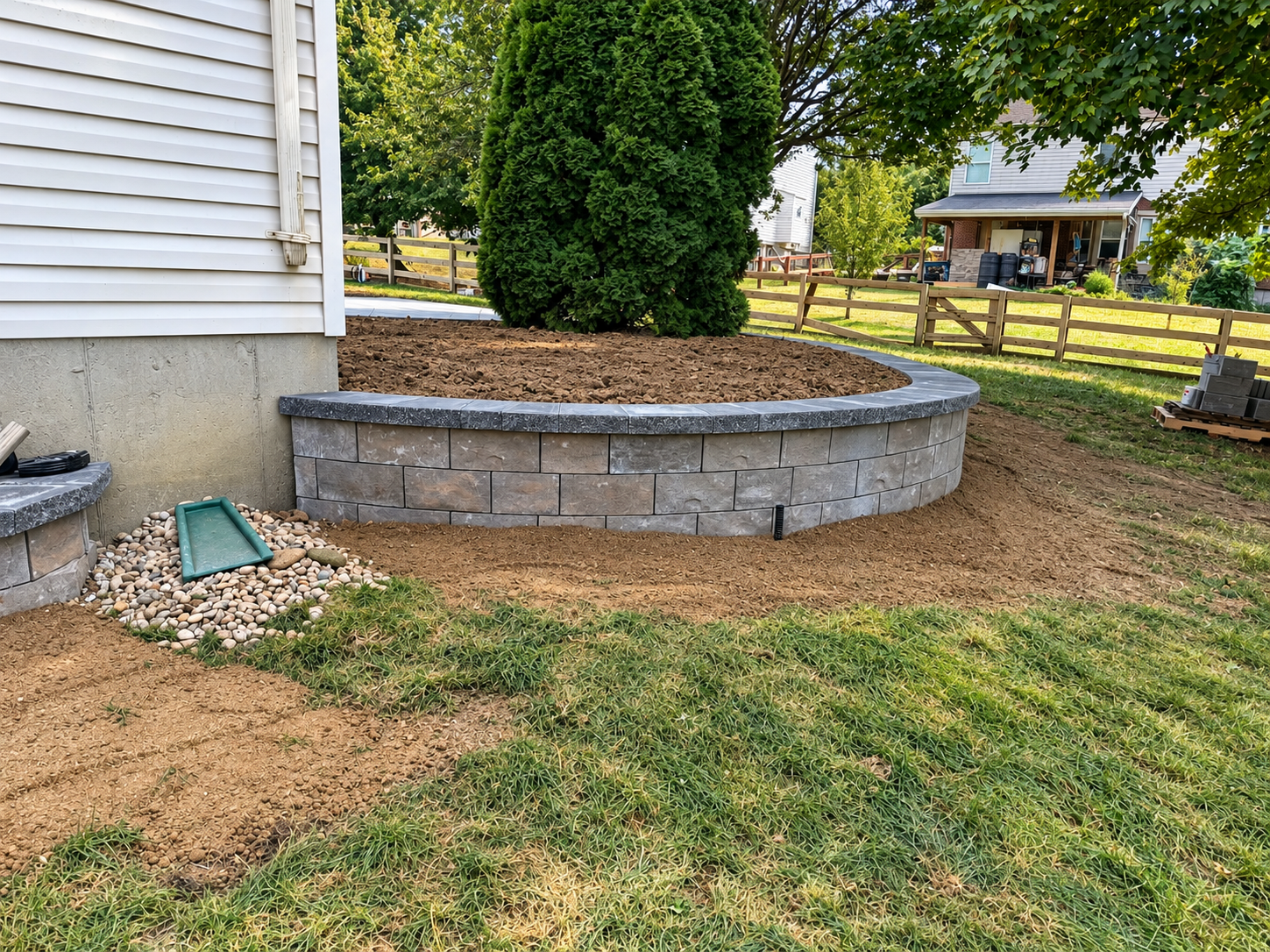 Curved paver retaining wall with planting bed